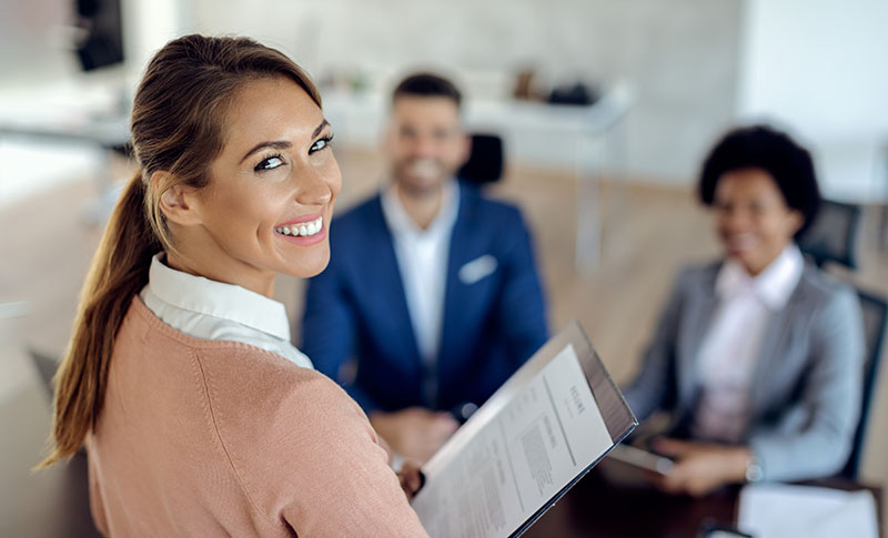 Young happy woman having an job interview in the office.